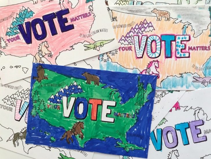 A bunch of postcards with an outline of America and the word VOTE filled in with marker
